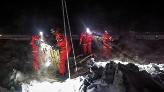 scientists with headlamps on ice, cleaning up eqipment