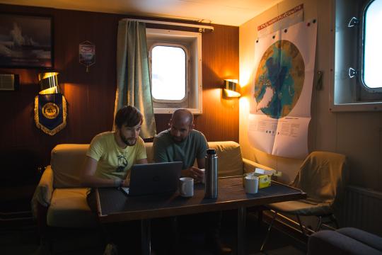 two researchers discussing weather on the Akademic Federov icebreaker