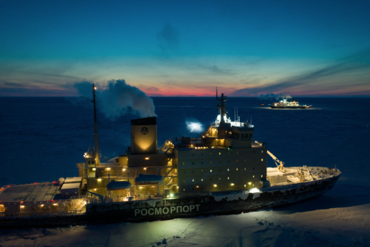 Two ships parked in the Arctic ice at twilight