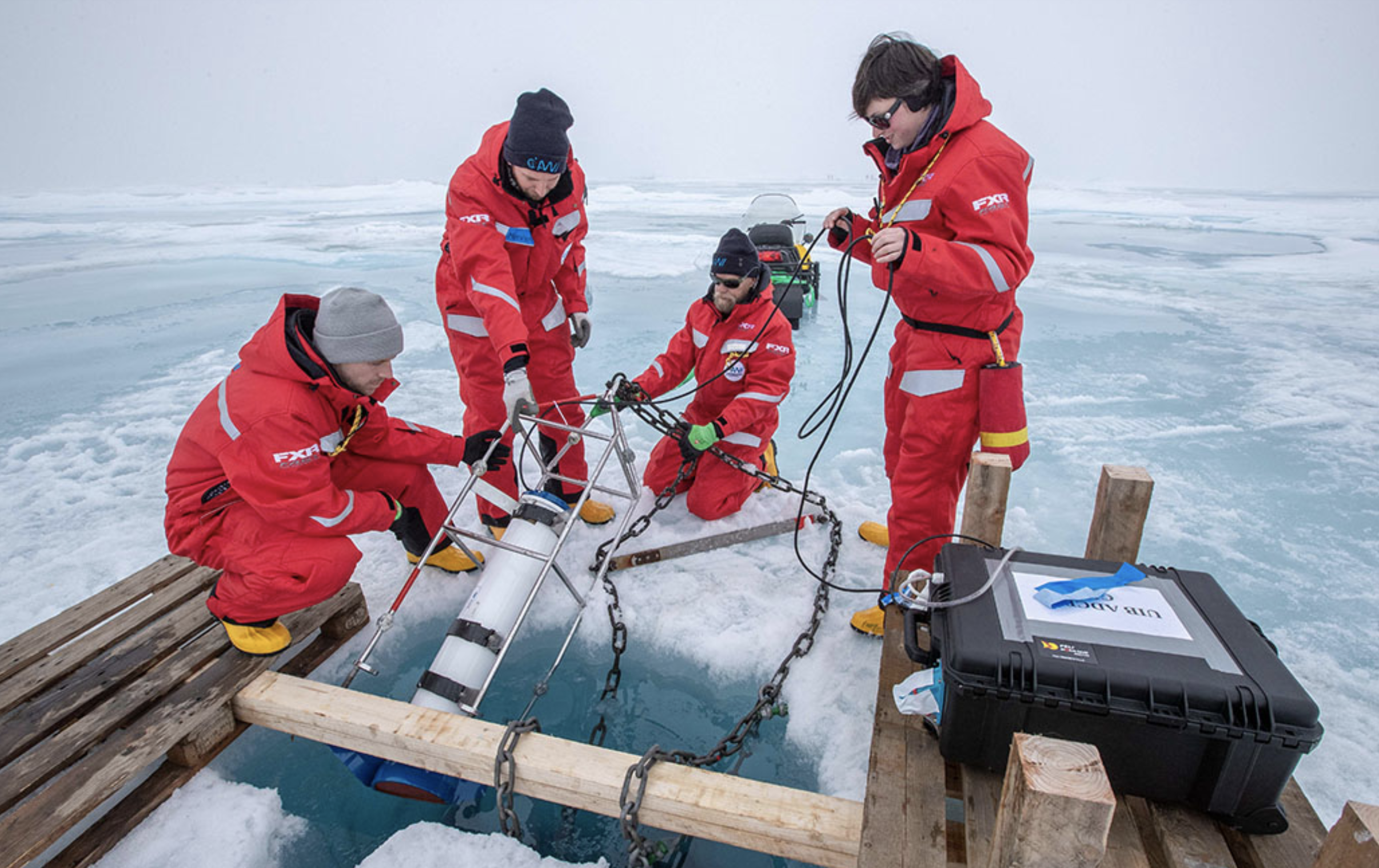 Team Ocean deploys an ADCP underneath the ice; Photo by Lianna Nixon