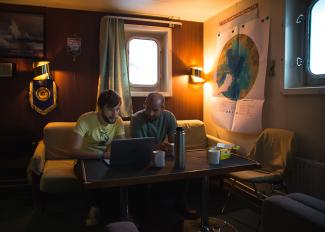 two researchers discussing weather on the Akademic Federov icebreaker