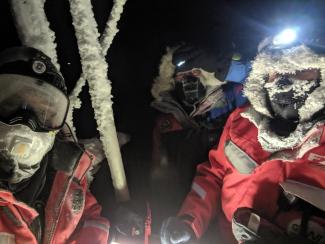 3 frosty people in the dark