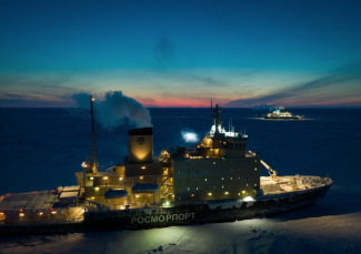 Two ships parked in the Arctic ice at twilight