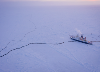 Ship sitting on long crack on the ice 