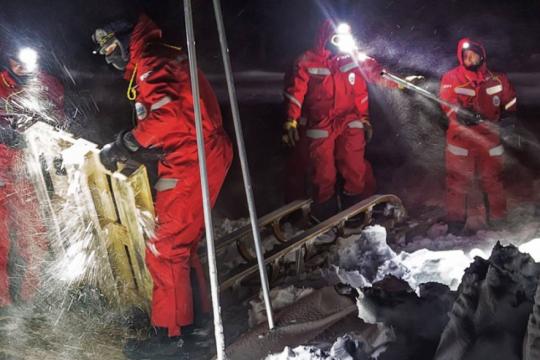 scientists repair equipment on ice