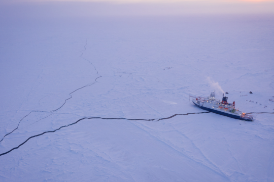Ship sitting on long crack on the ice 