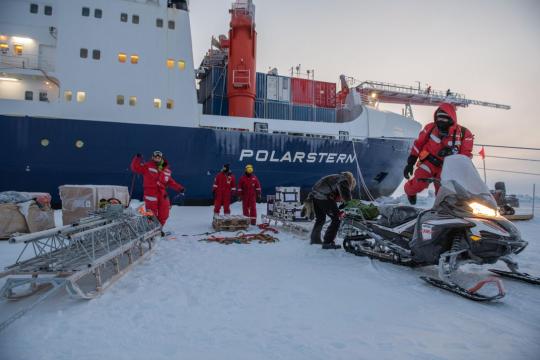 Researchers unload scientific instruments from the Polarstern and put them on sleds for delivery to Met City, located about 600 meters from the ship.