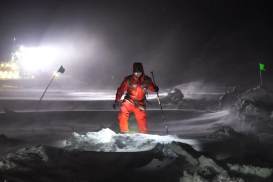 During a yearlong international mission on Arctic sea ice, CIRES’ Matthew Shupe heads to inspect and repair damage after a November storm tossed up new ice barriers and damaged equipment. (Amy Richman / CIRES and CU Boulder / Courtesy Photo)