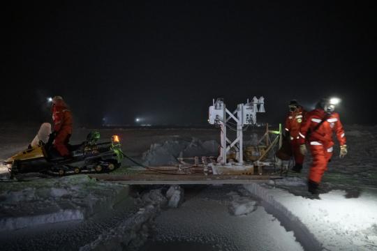 Scientists tow Stroeve's Ku/Ka radar across an opening in sea ice. Even in the heart of winter, sea ice is dynamic. Credit: Julienne Stroeve, NSIDC