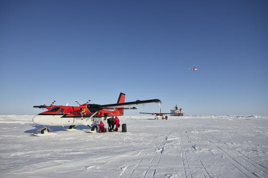 Twin Otter plane landing on the ice